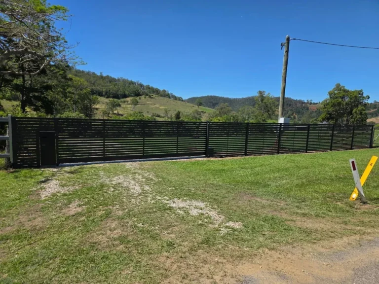 Horizontal slat sliding gate with pedestrian gate in black aluminium