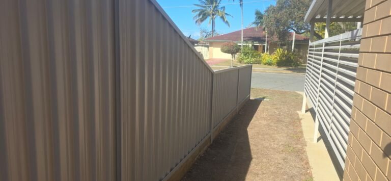 GramLine® steel fence in Birch stepping down to a lower height toward the street frontage, supplied in kit form by Accolade Fencing