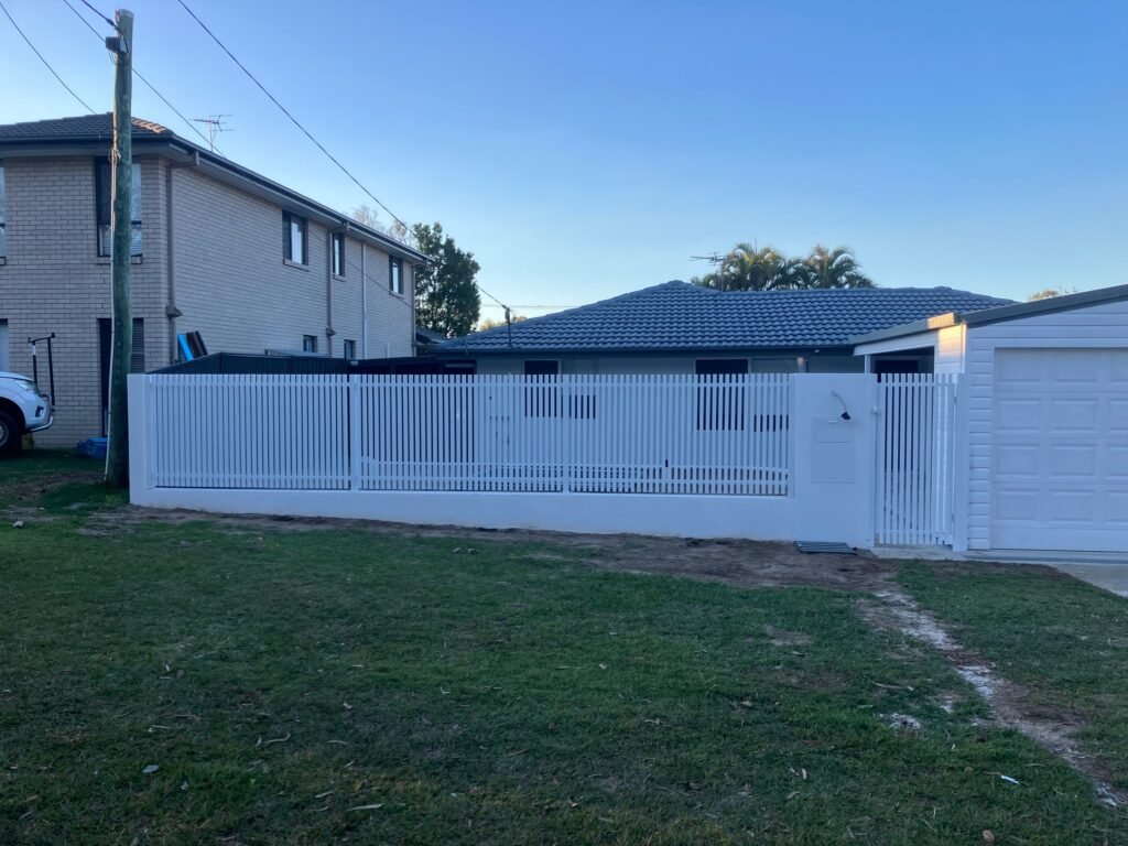 Pearl White RAD batten fence panels along a home frontage, 40x40 aluminium battens with 30mm gaps, custom manufactured by Accolade Fencing