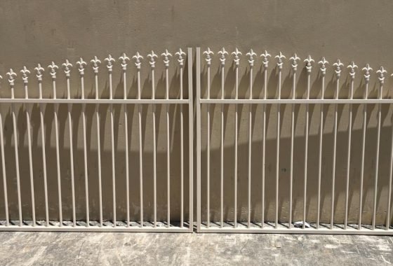 Fleur-de-Lis arched top swing gates custom fabricated